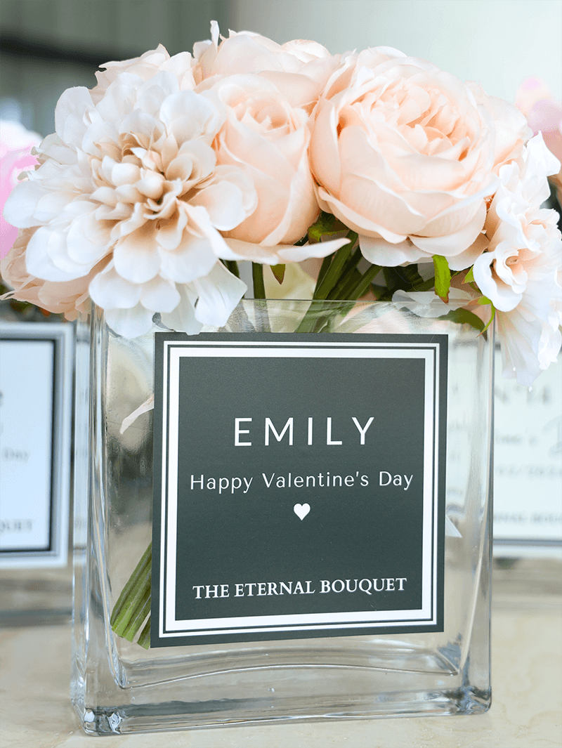 Beautiful flower arrangement, with hues of pink, beige, white, and more. Encased in a sleek, square glass vase, with a personalised label. Perfect for gifts for partners, anniversaries, and more romantic celebrations.