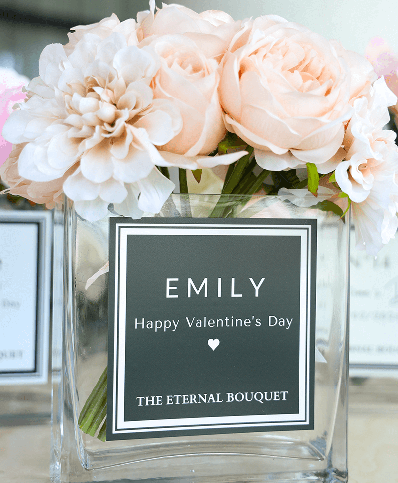 Beautiful flower arrangement, with hues of pink, beige, white, and more. Encased in a sleek, square glass vase, with a personalised label. Perfect for gifts for partners, anniversaries, and more romantic celebrations.