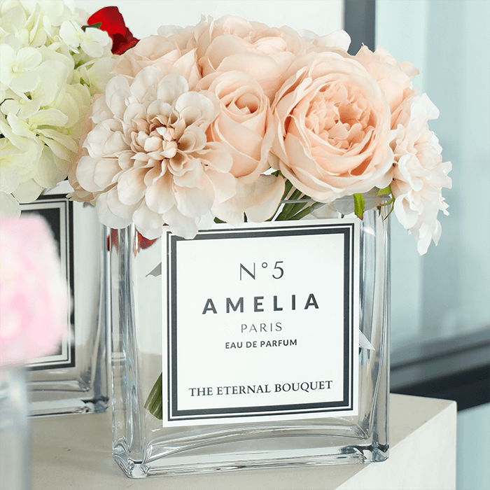 Beautiful flower arrangement, with hues of pink, beige, white, and more. Encased in a sleek, square glass vase, with a personalised label. Perfect for gifts for partners, anniversaries, and more romantic celebrations.