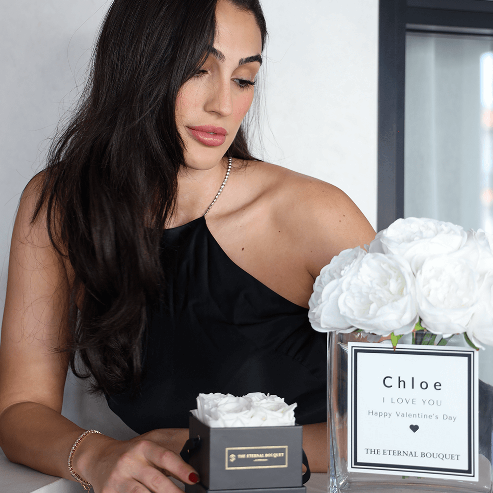 Luxury personalised glass vase with white scented silk peonies in a modern home setting
