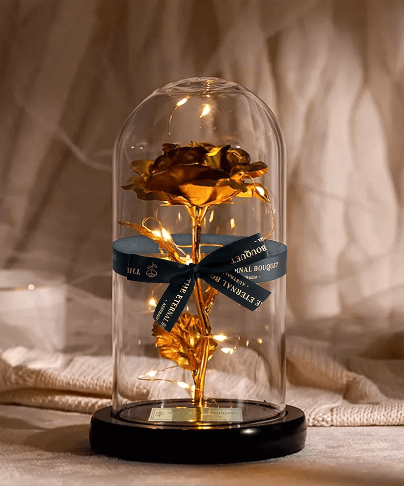 Elegant gold galaxy rose in a glass dome with soft LED lighting, the perfect luxury floral gift for special occasions.