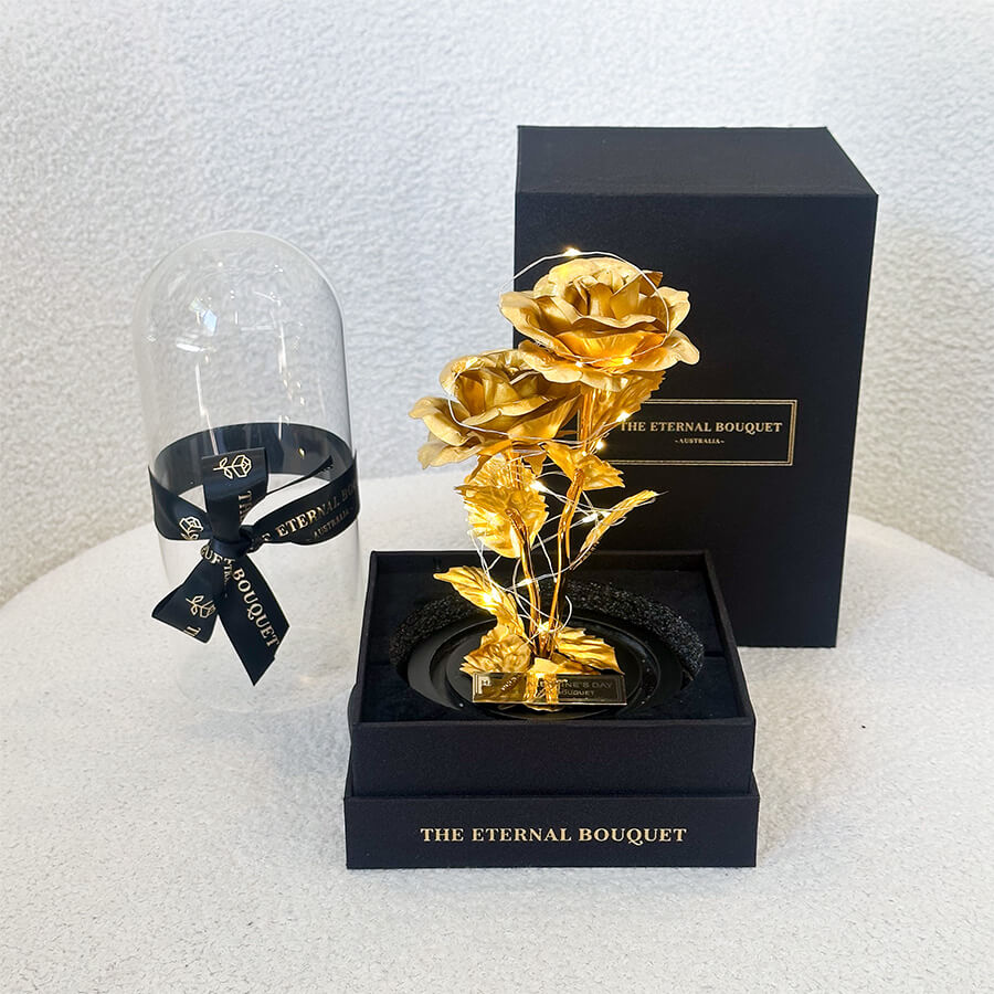 Luxury gold galaxy roses with LED lights in a glass dome, presented in a black gift box by The Eternal Bouquet Australia