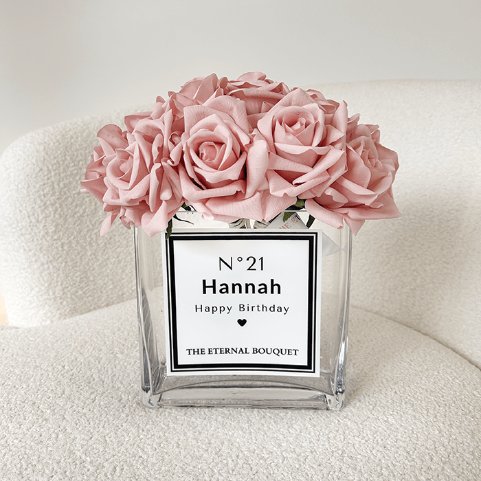 Beautiful everlasting pink roses, encased in a durable sleek rectangular glass vase, with a white personalised label.