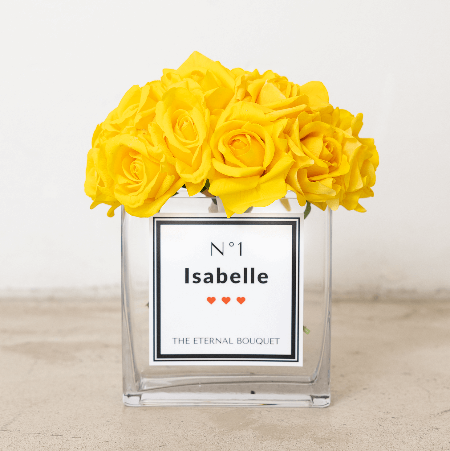 Yellow real touch roses in a personalised rectangular glass vase by The Eternal Bouquet with personalised label.
