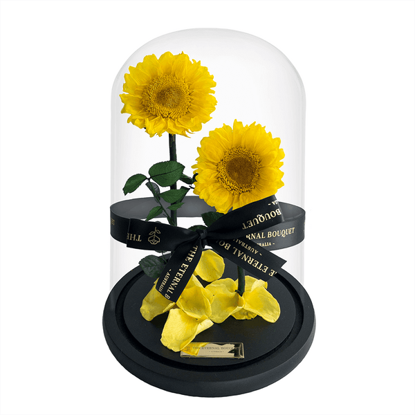 Two everlasting sunflowers under a glass dome with an engraved gold plaque by The Eternal Bouquet