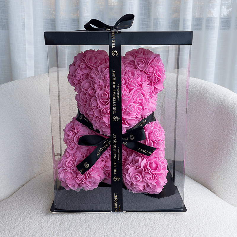 A stunning forever pink rose teddy bear from The Eternal Bouquet, crafted entirely from delicate everlasting roses and elegantly presented in a clear gift box with black ribbon detailing. A show-stopping, long-lasting gift perfect for birthdays, anniversaries, or anyone who deserves a little extra love.