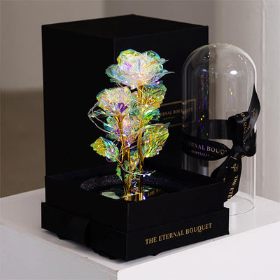 Three elegant white galaxy roses illuminated with warm LED lights inside a glass dome, a timeless gift idea for birthdays, anniversaries, and Mother's Day.