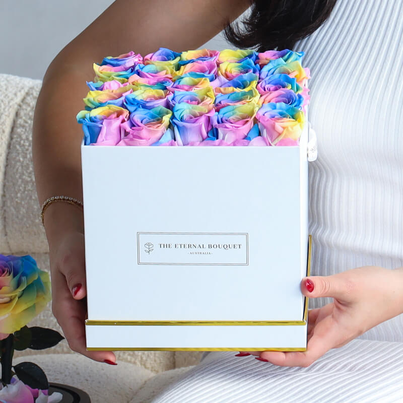 woman holding an everlasting Rainbow Rose box in a White Bouquet Box