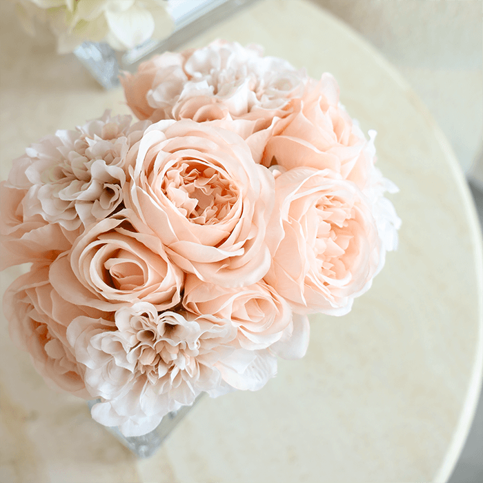 Beautiful blush bouquet, arranged wonderfully with hues of pink, beige, white and more. Encased in a square sleek glass vase. This is the perfect gift to commemorate romantic celebrations between partners or more. 