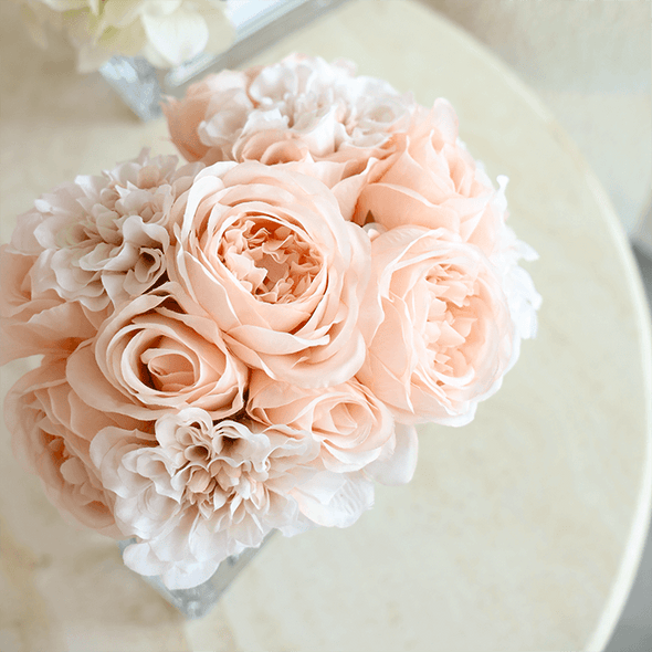 Beautiful blush bouquet, arranged wonderfully with hues of pink, beige, white and more. Encased in a square sleek glass vase. This is the perfect gift to commemorate romantic celebrations between partners or more. 