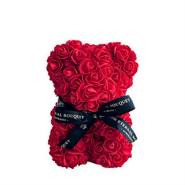 A stunning red rose teddy bear from The Eternal Bouquet, crafted entirely from vibrant everlasting roses and tied with an elegant black ribbon featuring gold foil branding. A romantic and lasting alternative to traditional floral gifts, this bear is perfect for Valentine’s Day, anniversaries, or any special occasion where love and thoughtfulness are celebrated.