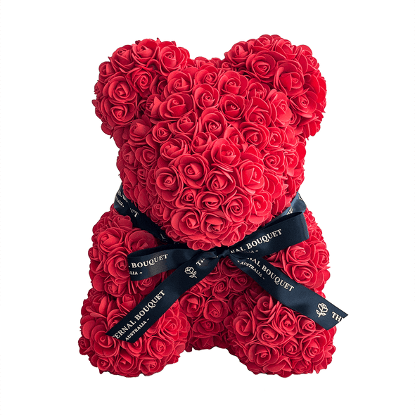 A handcrafted everlasting red rose teddy bear from The Eternal Bouquet, adorned with a sleek black ribbon featuring the brand’s logo. This luxurious and timeless gift makes a bold romantic statement, perfect for anniversaries, Valentine’s Day, or simply to show someone how deeply they’re loved.