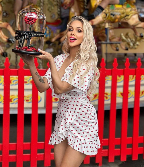 Pretty blonde girl holding a red everlasting rose